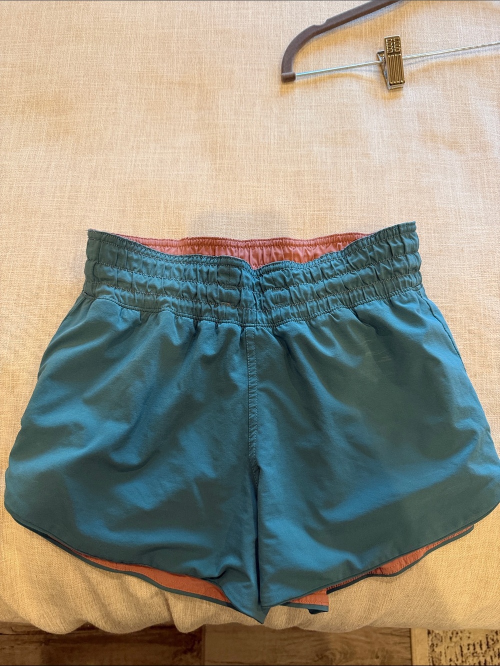 Lululemon Side shorts feature a reversible design in teal and pink.